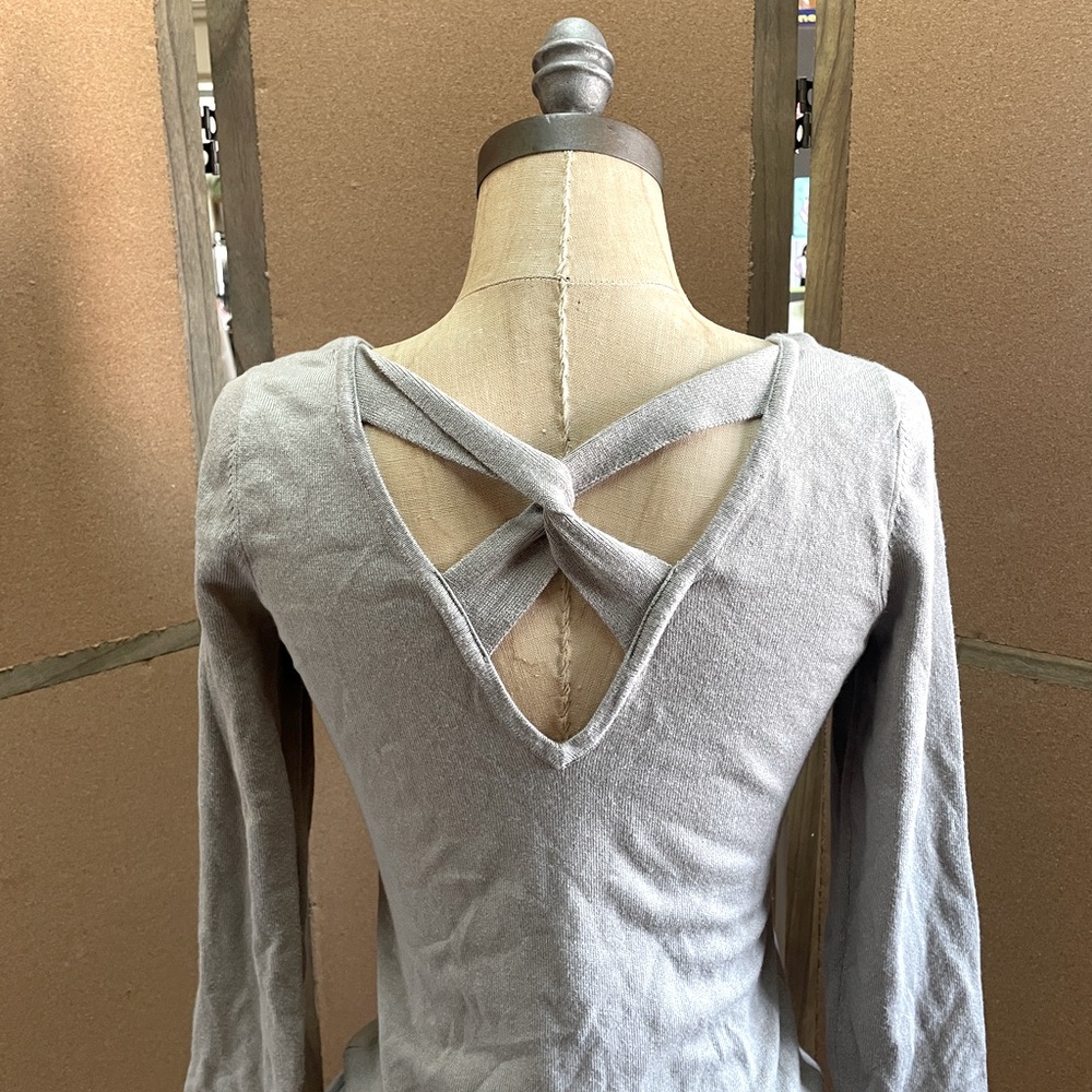 Guess V-neck sweater with open back design.